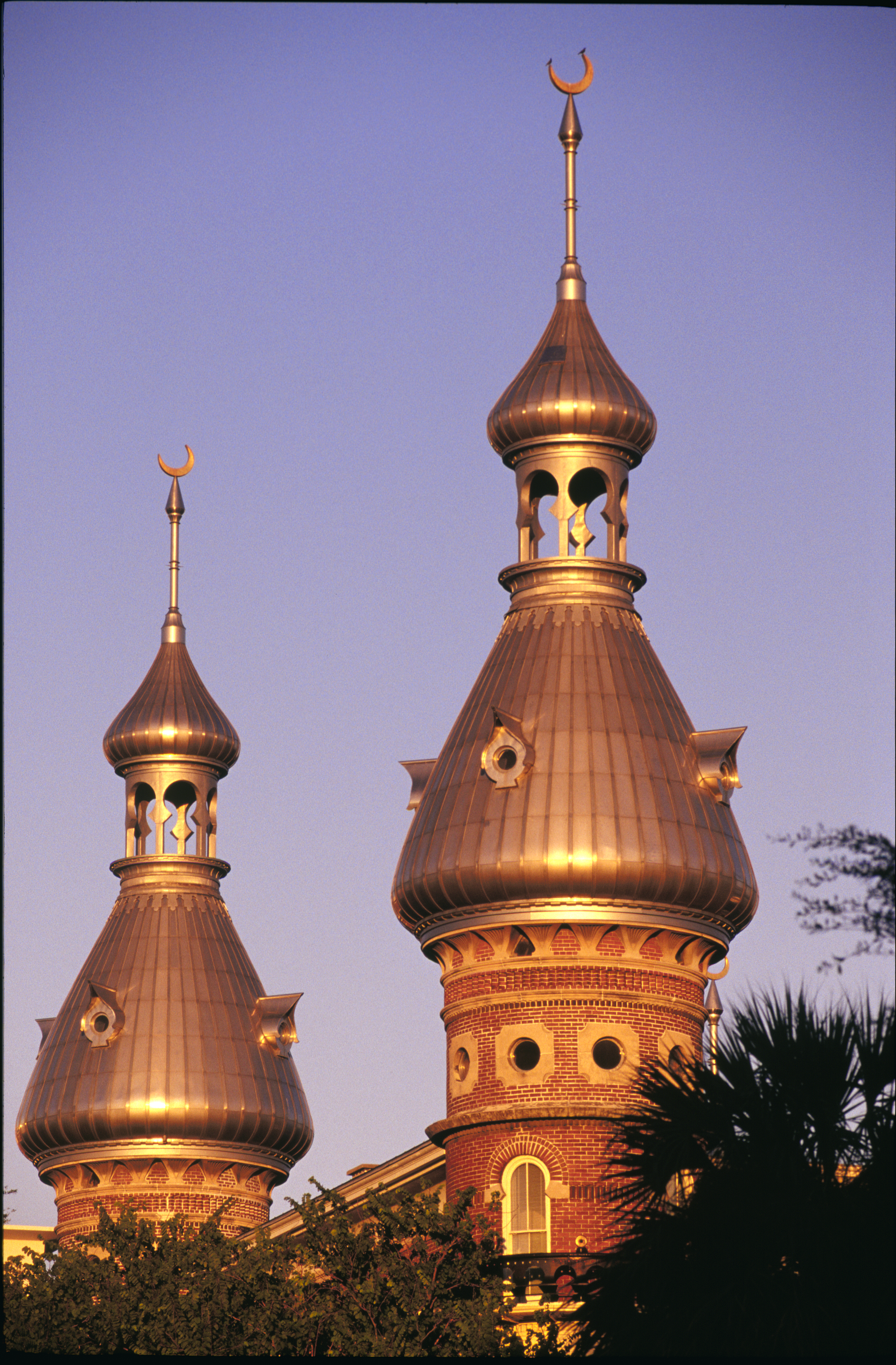 The sun shines on two towers of Plant Hall at the University of Tampa.