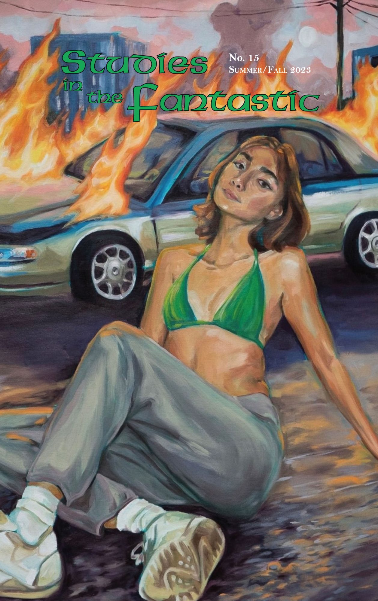 Image of the front cover of Studies in the Fantastic No. 15. A young woman in a bra or bikini top poses in the foreground of an urban landscape and a burning car.